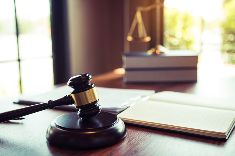 Legal gavel and law books on a desk for an experienced law firm serving Bloomfield Hills.